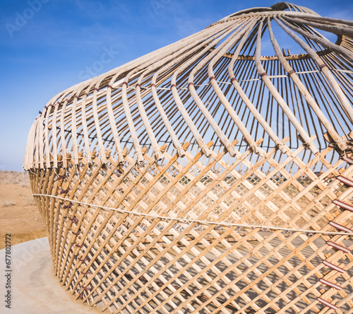 Asian yurt frame made of wooden poles and sticks on a sunny summer day