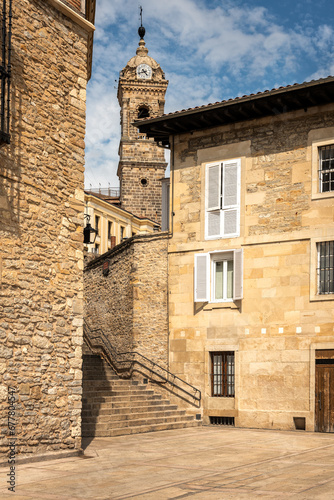 Fototapeta Naklejka Na Ścianę i Meble -  Tower with clock of the church of San Vicente Martir, 15th-16th century in Gothic and Renaissance style, among the stone houses of the old town, Vitoria-Gasteiz, Alava, Basque Country, Spain