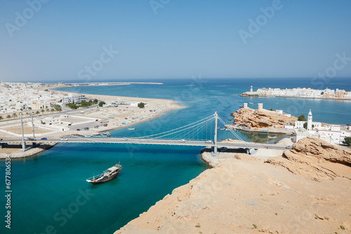 Sur cityscape with Al Aygaz Suspension Bridge. Travel destination on coast of the Gulf of Oman. .
