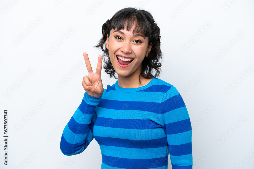 Young Argentinian woman isolated on white background smiling and showing victory sign Young Argentinian woman isolated on white background smiling and showing victory sign