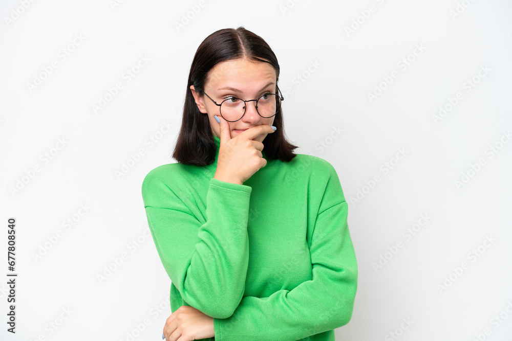 Young caucasian woman isolated on white background having doubts and with confuse face expression Young caucasian woman isolated on white background having doubts and with confuse face expression