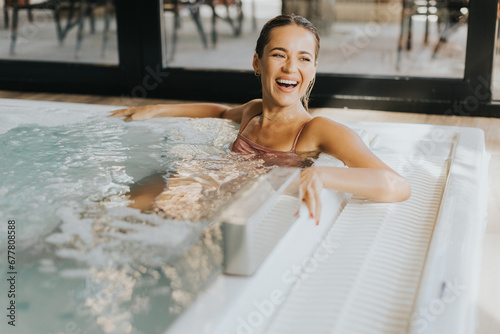 Young woman relaxing in the indoor bubble pool
