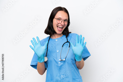 Young nurse caucasian woman isolated on white background counting ten with fingers