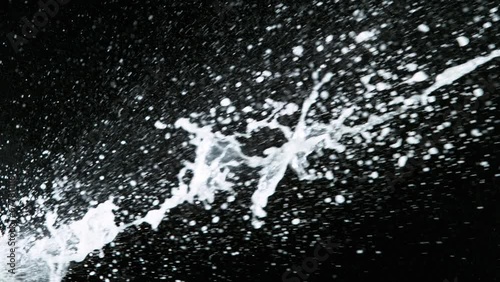 Super slow motion of Champagne explosion with flying cork closure, black background, opening champagne bottle closeup. photo