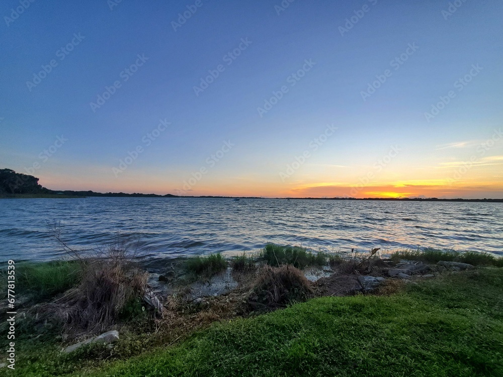 Serene seascape surrounded by grass