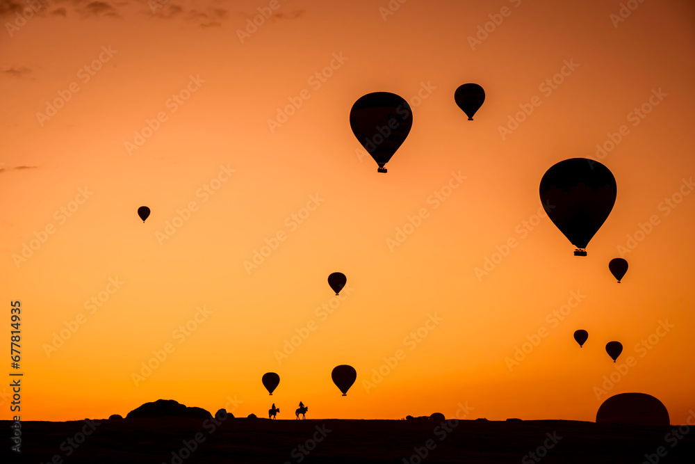 Fototapeta premium Air balloons at sunset over Cappadocia-Goreme, Turkey, Oct. 20th,2022. A vibrant explosion of light and color, and the enthusiasm of flying an air balloon over the strange rock formation.