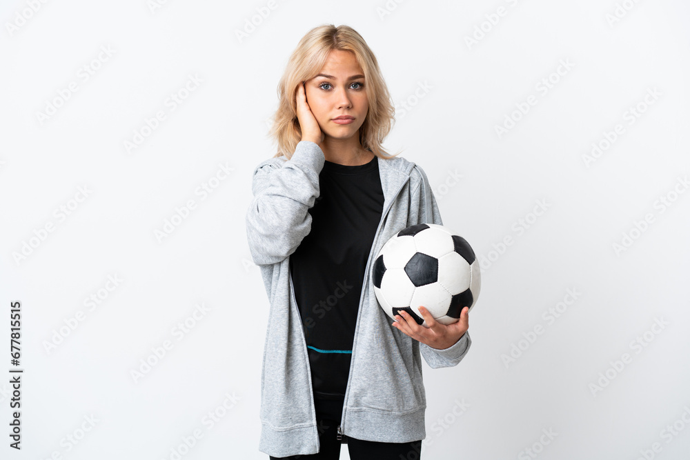 Young Russian woman playing football isolated on white background frustrated and covering ears