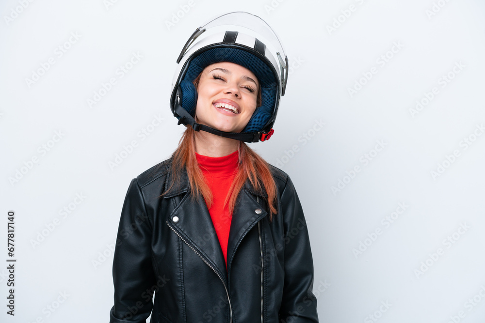 Young Russian girl with a motorcycle helmet isolated on white background laughing Young Russian girl with a motorcycle helmet isolated on white background laughing