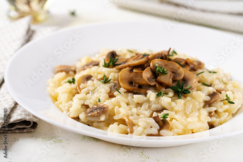 Dish with delicious risotto with mushrooms in plate. Rice porridge with fungus and tmyne. Hot dish  italian cuisine.