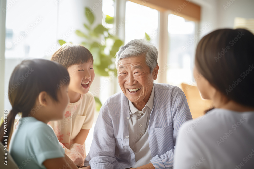 An asian grandfather shares funny anecdotes with his three granddaughters, sharing fun and joyful moments together as a family, indoors. - obrazy, fototapety, plakaty 