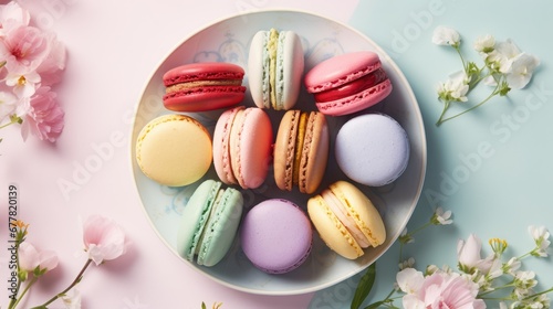  a plate of colorful macaroons and flowers on a blue and pink background with space for text or image. photo