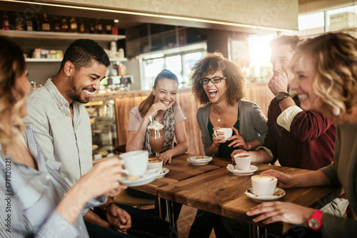 Group of Happy friends having coffee together in cafe or bar photo