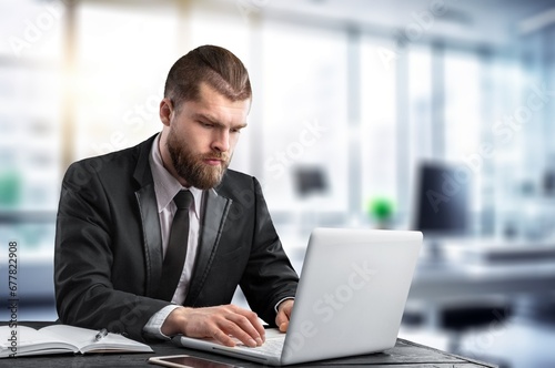 Happy smiling professional businessman sitting at office
