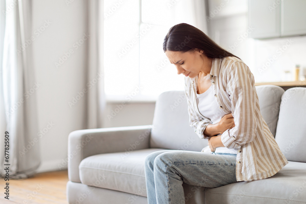 Digestion Problems. Sick Young Woman Suffering From Acute Abdominal Pain At Home Digestion Problems. Sick Young Woman Suffering From Acute Abdominal Pain At Home