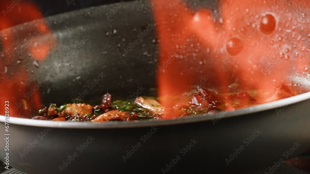 Flambe Fried chanterelle mushrooms with onion and parsley in a frying pan and the ingredients cooking i9n restaurant, autumn menu in cafe. Flambe Fried chanterelle mushrooms with onion and parsley in a frying pan and the ingredients cooking i9n restaurant, autumn menu in cafe.