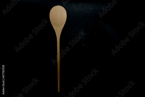 wooden spoon on black background