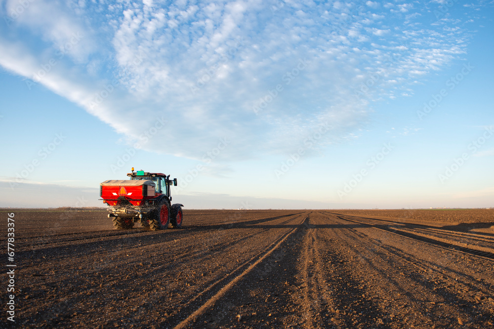 Tractor spreading artificial fertilizers Tractor spreading artificial fertilizers