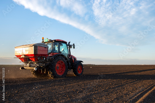 Schilderij op canvas Tractor spreading artificial fertilizers
