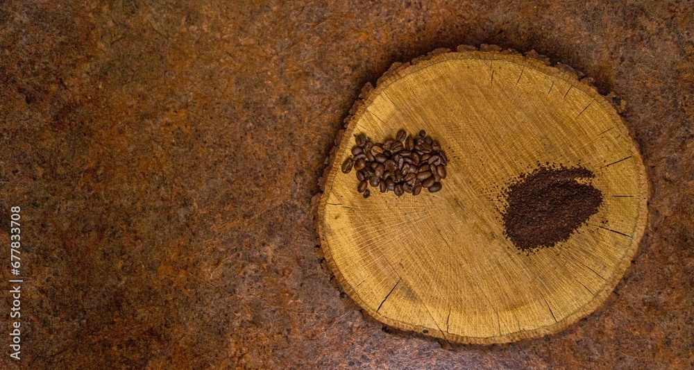 Top view of the ground coffee and coffee beans on a log Top view of the ground coffee and coffee beans on a log
