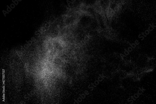 Abstract splashes of water on black background. Freeze motion of white particles. Rain, snow overlay texture. 