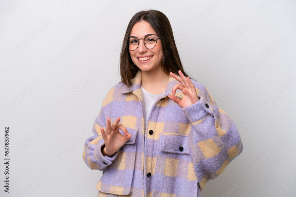 Young girl isolated on white background showing ok sign with two hands Young girl isolated on white background showing ok sign with two hands
