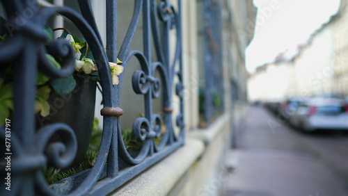 European Sidewalk Framed by Elegant Window Security metal gate demarcating property protection photo