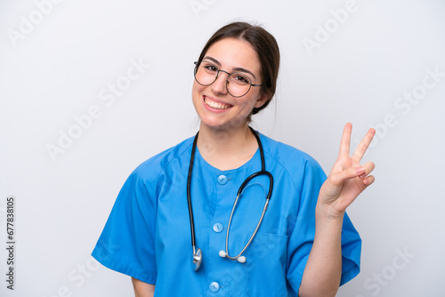 surgeon doctor woman holding tools isolated on white background smiling and showing victory sign © luismolinero