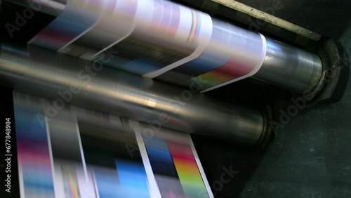 Flyers, newspapers, leaflets on the conveyor belt in a printing house photo