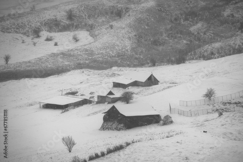 rural winter landscape in the hill area with households and human activities