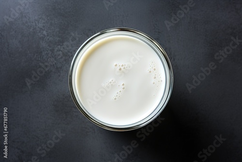 a glass of milk with a dark surface, a glass of milk