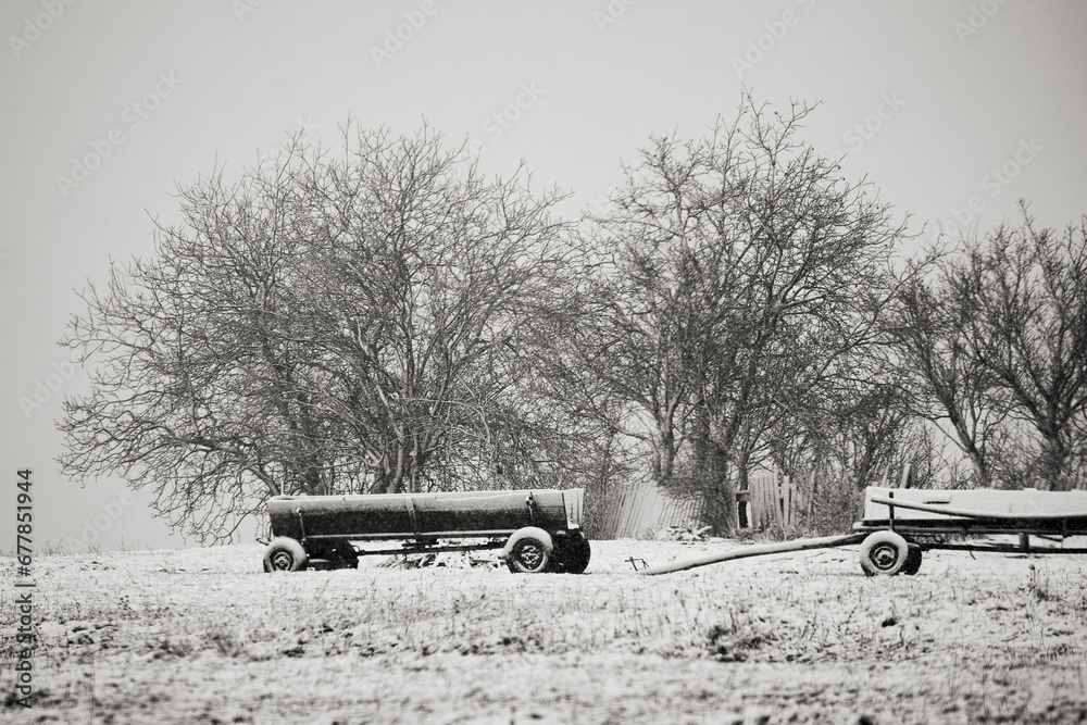 wagon covered with snow in winter in the country