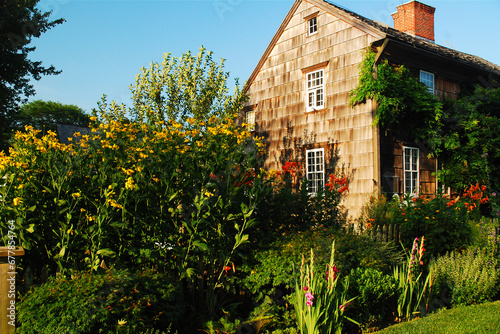 A summer garden is planted in the front yard of a historic farm house in East Hampton, Long Island. one of the towns of the Hamptons