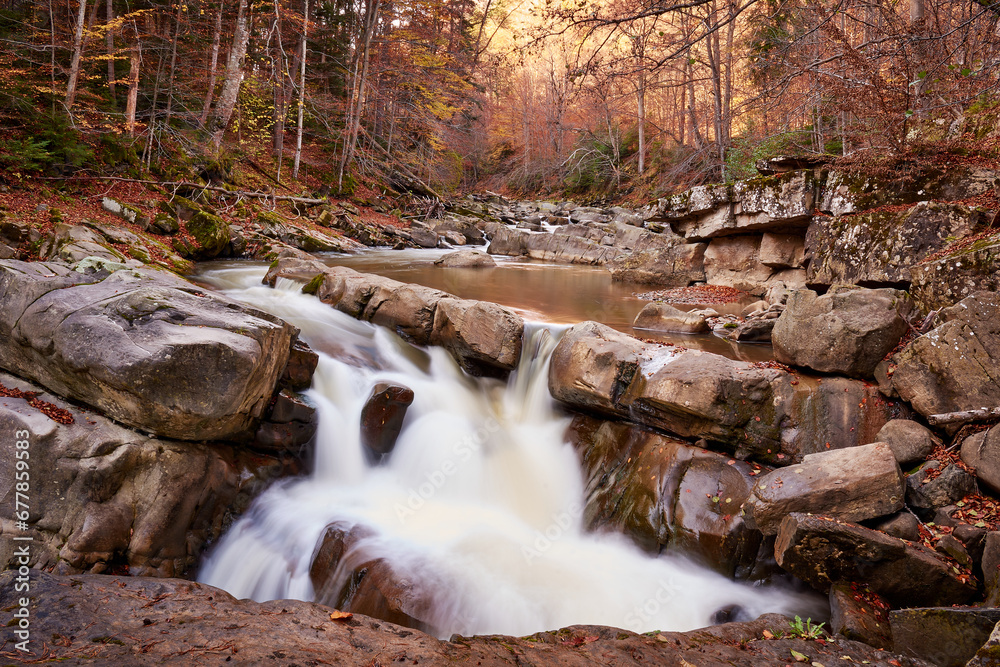 autumn landscape with mountain river and silky waterfall
