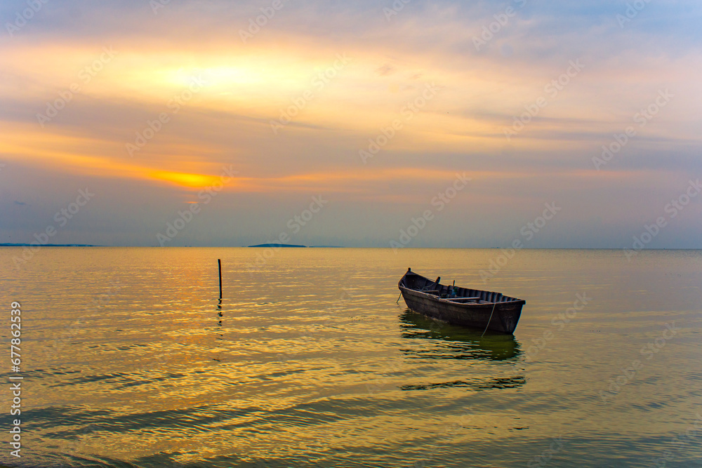 boat at sunrise on the lake