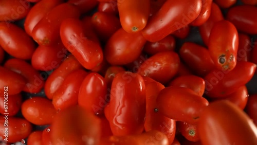 Tasty, wet red tomatoes are falling photo