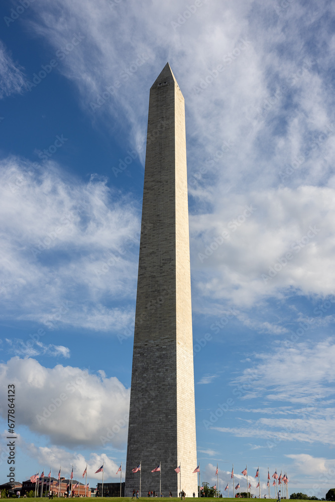 Washington D.C. Monument with blue sky and USA flags