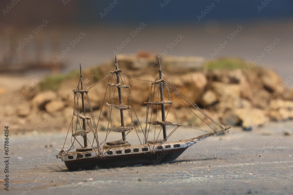 Fototapeta premium Closeup shot of a small wooden boat on the ground