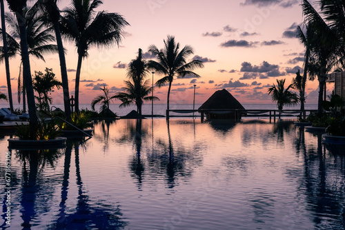 Sunrise over the Gulf of Mexico reflected into the infinity pool at the resort © John McAdorey