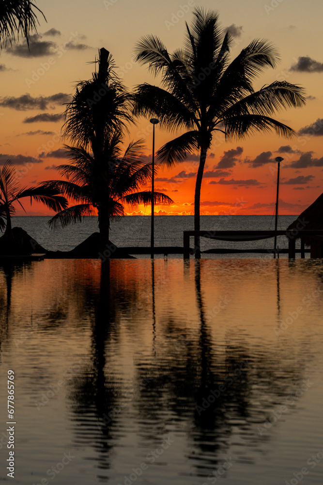 Sunrise over the Gulf of Mexico reflected into the infinity pool at the resort
