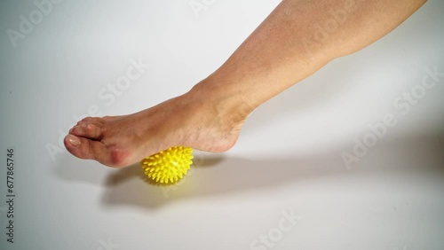 Hallux valgus disease of the legs. Massage with a ball. One foot. photo