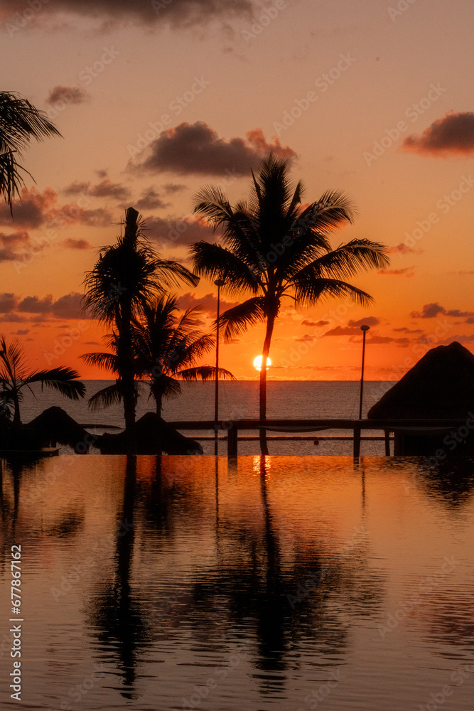 Sunrise over the Gulf of Mexico reflected into the infinity pool at the resort Sunrise over the Gulf of Mexico reflected into the infinity pool at the resort
