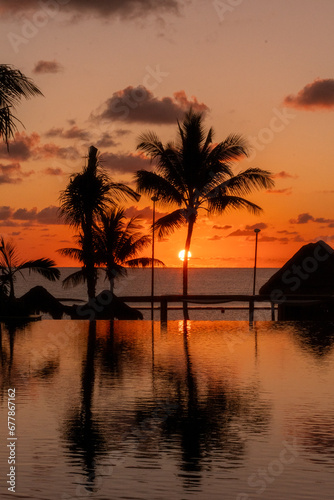 Sunrise over the Gulf of Mexico reflected into the infinity pool at the resort © John McAdorey