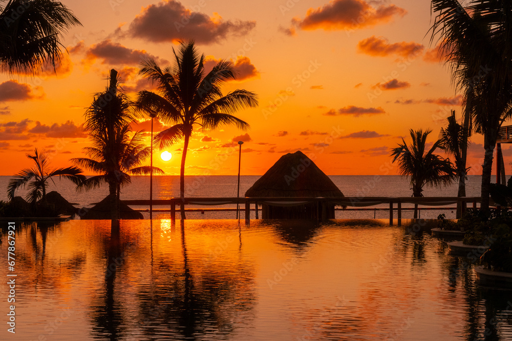 Sunrise over the Gulf of Mexico reflected into the infinity pool at the resort