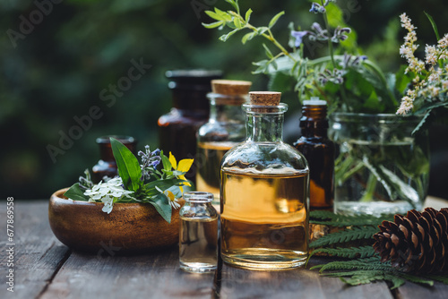 Concept of pure organic essential oil in glass bottles in cosmetology. Moisturising skin care, aromatherapy. Gentle body treatment. Atmosphere of harmony, relax. Wooden background, natural ingredients