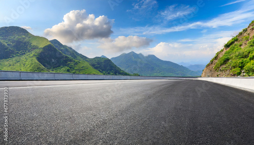 straight asphalt road and mountain under blue sky highway and mountain background © Emanuel