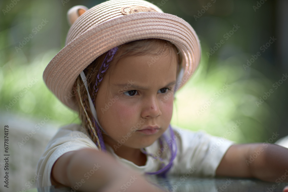 portrait of a cute child in a hat with ears