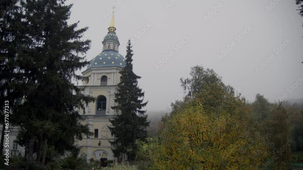 The bell tower of the Vydubychi Monastery. The courtyard of the Orthodox monastery in autumn. The bell tower of the Vydubychi Monastery. The courtyard of the Orthodox monastery in autumn.