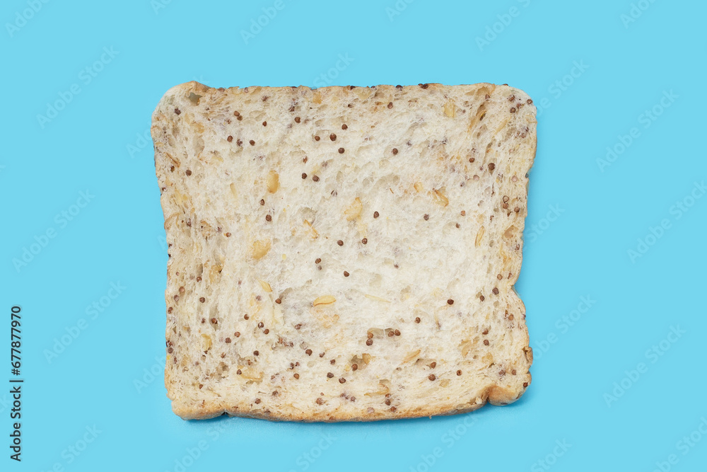 Whole grain bread slices on blue background.