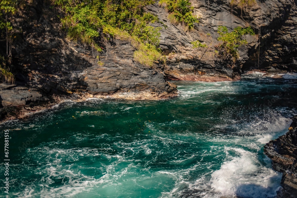 Foamy river flowing between rocks on a sunny day Foamy river flowing between rocks on a sunny day