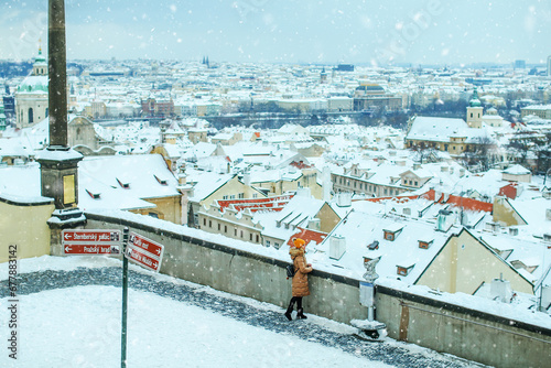 Portrait of cute happy woman enjoy snowfall in beautiful Prague city, enjoying winter holidays